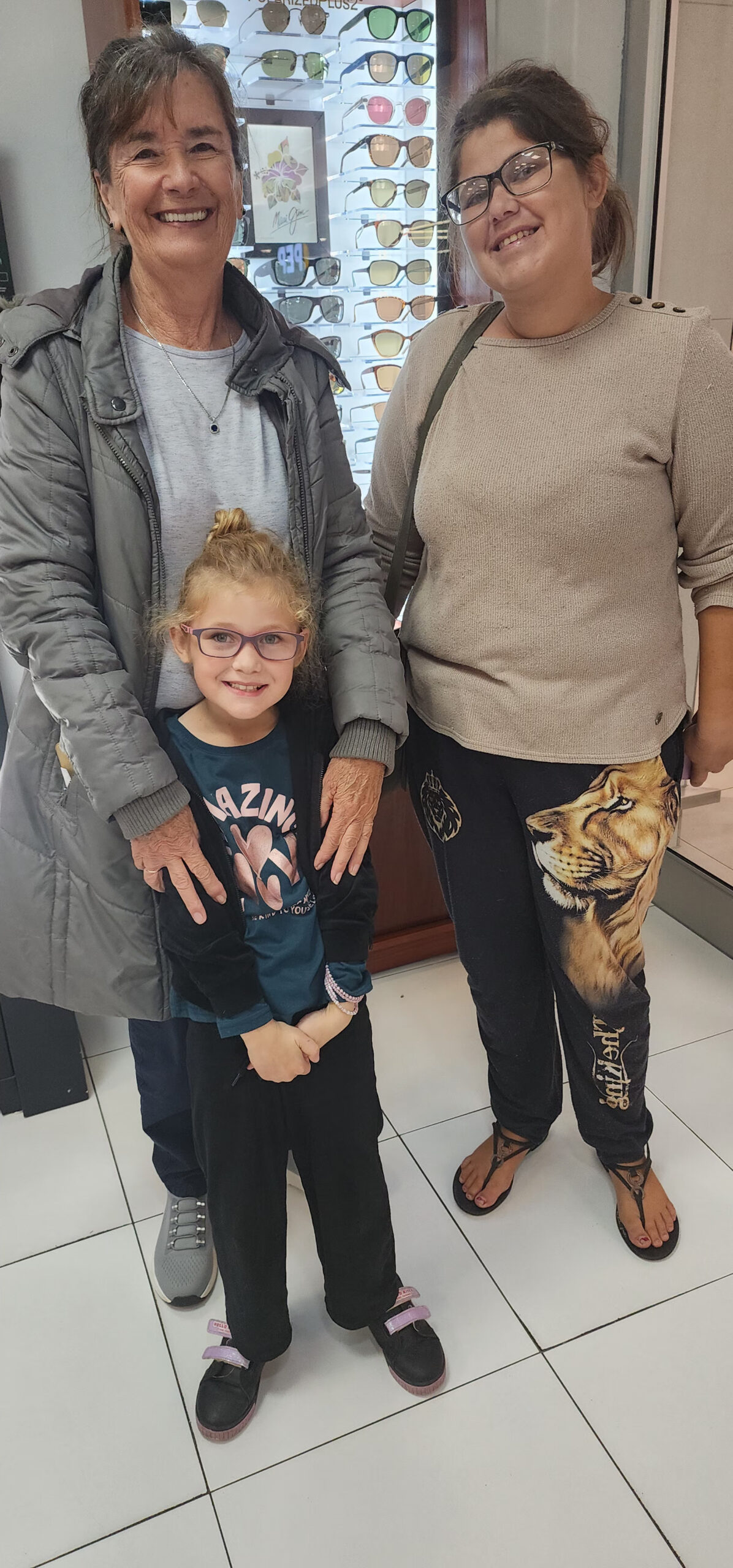 9 year old Candice receiving spectacles from Lions Brightsight . 60 learners vision screened in Ocean View